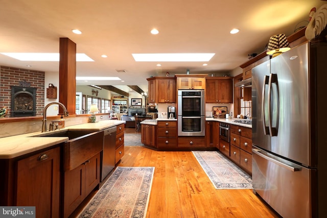 320 Hartswick Ave, State College, PA 16803 - kitchen featuring stainless steel appliances, open floor plan, a skylight, recessed lighting, and light wood-type flooring