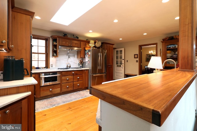320 Hartswick Ave, State College, PA 16803 - kitchen with appliances with stainless steel finishes, recessed lighting, light countertops, light wood-style floors, and brown cabinetry