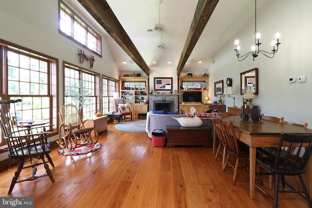 320 Hartswick Ave, State College, PA 16803 - living room featuring beamed ceiling, a fireplace, light wood-type flooring, a chandelier, and high vaulted ceiling