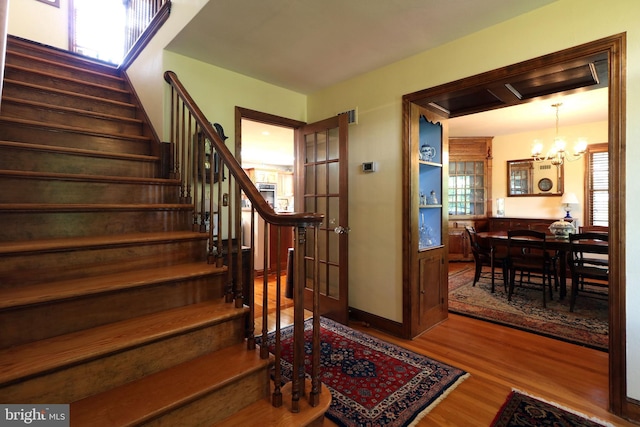 320 Hartswick Ave, State College, PA 16803 - stairs featuring wood finished floors, a chandelier, and plenty of natural light