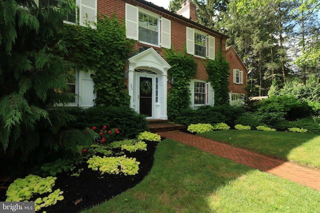 320 Hartswick Ave, State College, PA 16803 - view of front of house featuring a chimney, a front yard, and brick siding