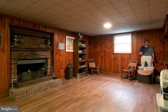 320 Hartswick Ave, State College, PA 16803 - sitting room featuring wood finished floors, wood walls, and a fireplace