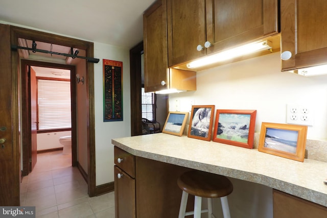 320 Hartswick Ave, State College, PA 16803 - kitchen featuring light tile patterned floors, a kitchen bar, and light countertops