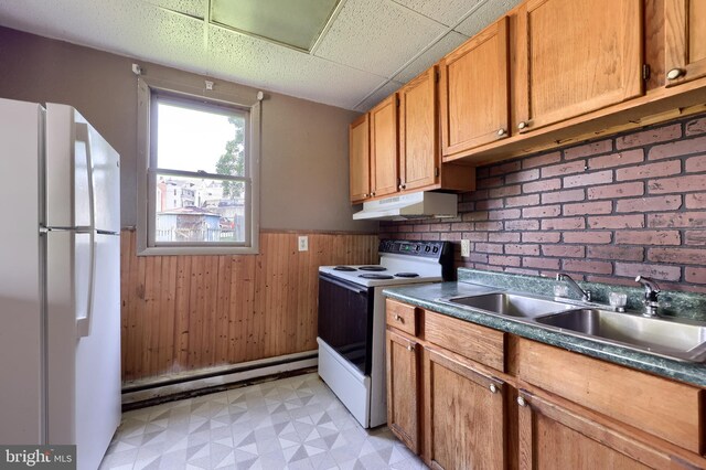 521 Concord Ln, Columbia, PA 17512 - kitchen featuring white appliances, under cabinet range hood, baseboard heating, wainscoting, and light flooring