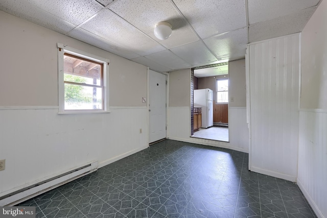 521 Concord Ln, Columbia, PA 17512 - spare room featuring a wainscoted wall, a baseboard heating unit, a paneled ceiling, and dark flooring