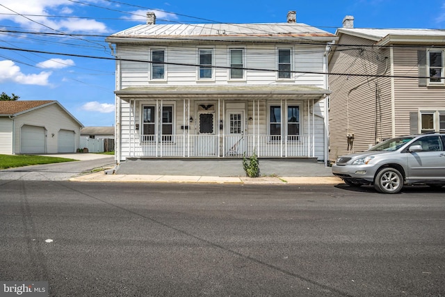 345-347 W Penn St, Carlisle, PA 17013 - view of front of home featuring covered porch, a chimney, a garage, and a metal roof