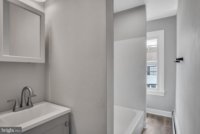 345-347 W Penn St, Carlisle, PA 17013 - bathroom featuring vanity, healthy amount of natural light, a bathtub, and wood finished floors