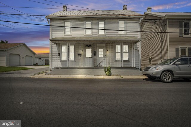 345-347 W Penn St, Carlisle, PA 17013 - view of property featuring a porch, a chimney, and an outdoor structure
