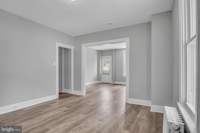 345-347 W Penn St, Carlisle, PA 17013 - empty room with radiator, wood finished floors, and a smoke detector