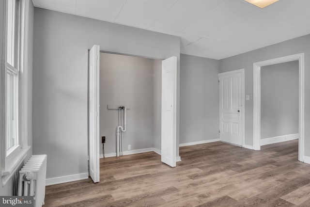 345-347 W Penn St, Carlisle, PA 17013 - unfurnished bedroom featuring radiator heating unit, wood finished floors, and a drop ceiling