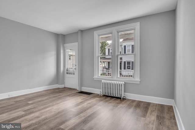 345-347 W Penn St, Carlisle, PA 17013 - empty room with radiator and wood finished floors