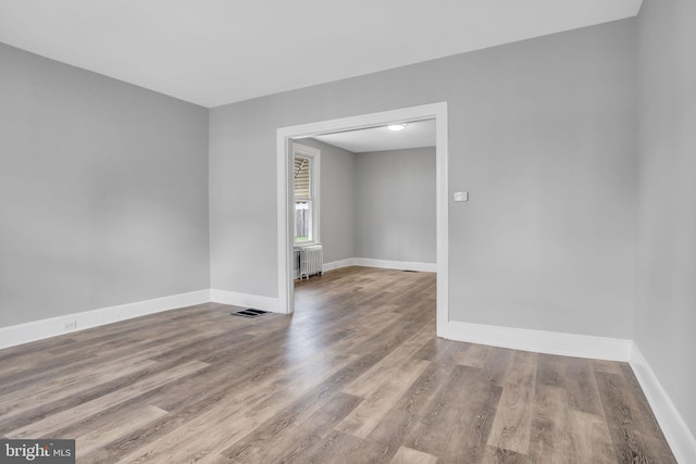 345-347 W Penn St, Carlisle, PA 17013 - spare room featuring radiator and wood finished floors