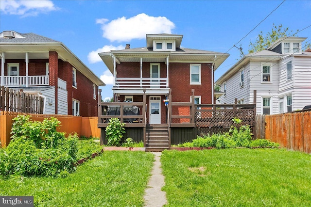 708 Maryland Ave, York, PA 17404 - back of house featuring a fenced backyard, brick siding, a balcony, and a deck