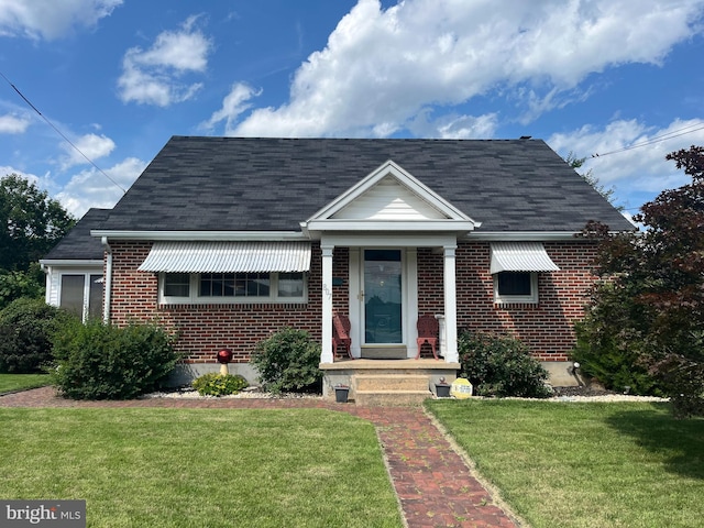 807 W Race St, Pottstown, PA 19464 - bungalow-style home with brick siding, a front yard, and a shingled roof