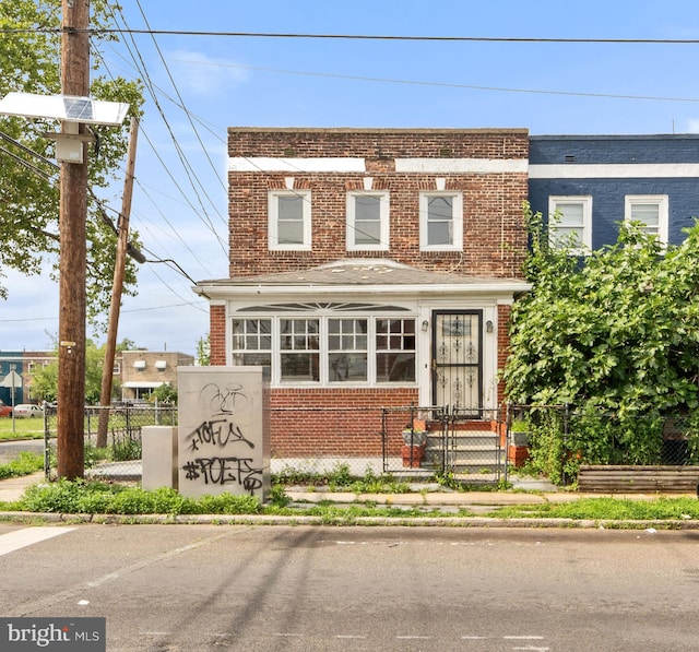 901 Fairview St, Camden, NJ 08104 - view of front of home featuring brick siding, a fenced front yard, and a gate
