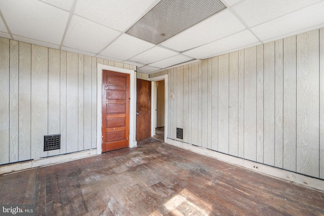 901 Fairview St, Camden, NJ 08104 - empty room with hardwood / wood-style flooring, wooden walls, and a drop ceiling
