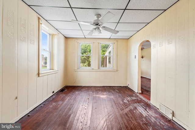 901 Fairview St, Camden, NJ 08104 - spare room with wood-type flooring, a paneled ceiling, arched walkways, ceiling fan, and wood walls