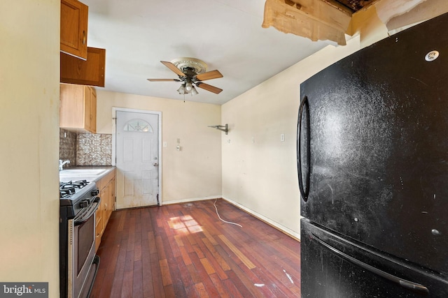 901 Fairview St, Camden, NJ 08104 - kitchen featuring freestanding refrigerator, gas range, decorative backsplash, dark wood finished floors, and ceiling fan