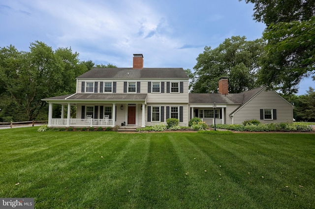 1228 Hunsicker Rd, Lancaster, PA 17601 - view of front of house with a chimney, a porch, and a front lawn