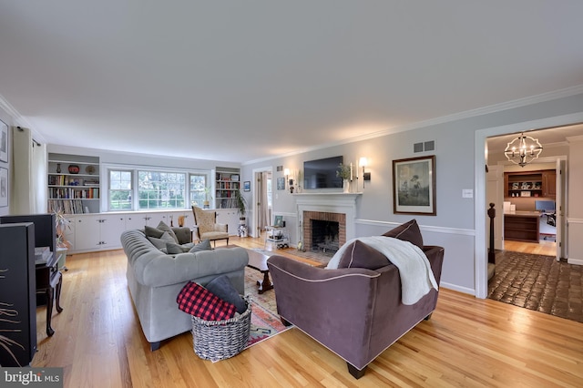 1228 Hunsicker Rd, Lancaster, PA 17601 - living area featuring ornamental molding, a fireplace, a chandelier, and wood finished floors