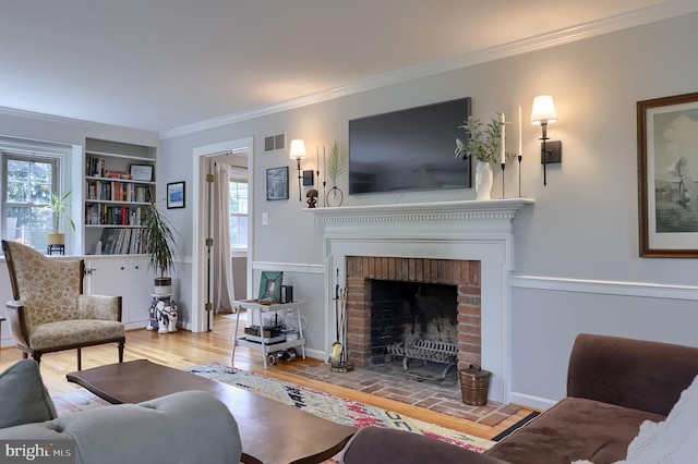 1228 Hunsicker Rd, Lancaster, PA 17601 - living area featuring crown molding, plenty of natural light, a brick fireplace, and wood finished floors
