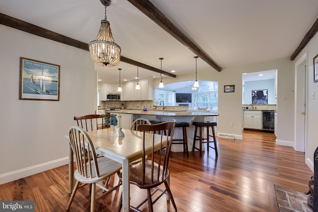 1228 Hunsicker Rd, Lancaster, PA 17601 - dining space with beverage cooler, beam ceiling, wood-type flooring, a chandelier, and recessed lighting