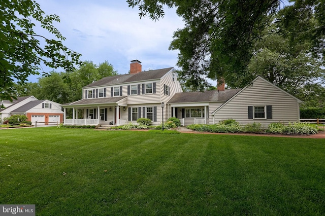 1228 Hunsicker Rd, Lancaster, PA 17601 - view of front of home featuring covered porch, a chimney, a front lawn, and roof with shingles