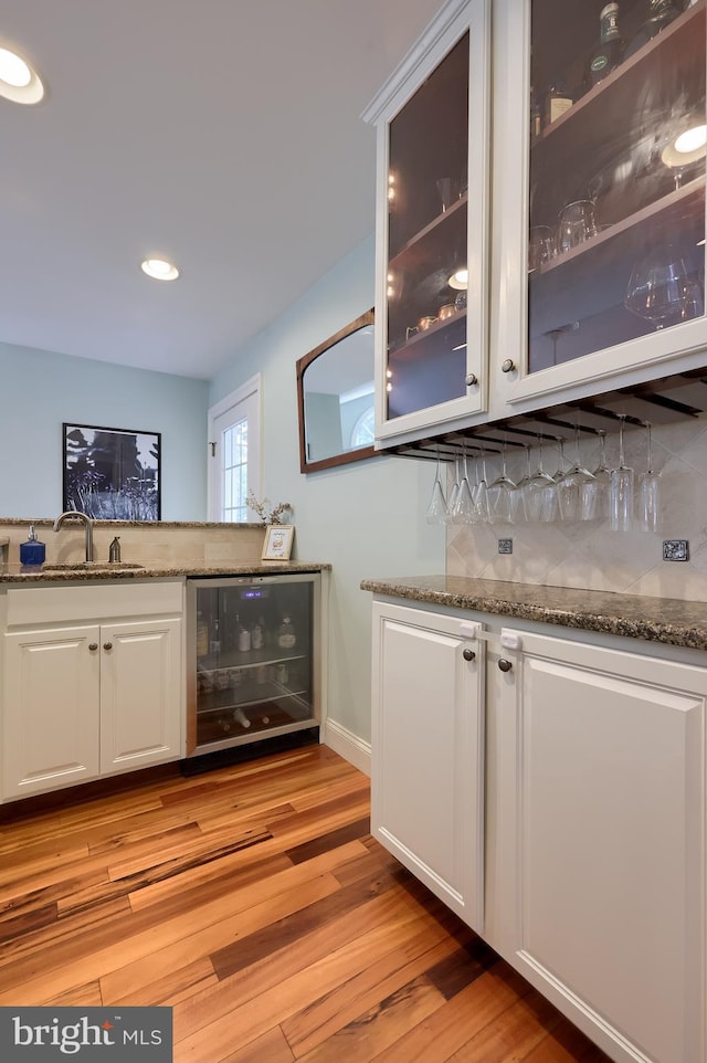 1228 Hunsicker Rd, Lancaster, PA 17601 - indoor dry bar with wine cooler, light wood-style flooring, decorative backsplash, and recessed lighting