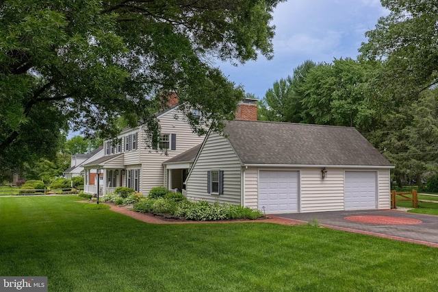 1228 Hunsicker Rd, Lancaster, PA 17601 - view of front of home featuring a garage, a chimney, a front yard, and roof with shingles