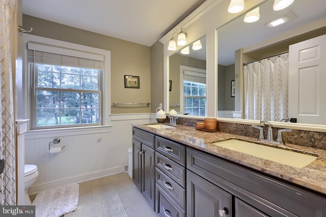 1228 Hunsicker Rd, Lancaster, PA 17601 - full bath featuring double vanity, tile patterned floors, and wainscoting