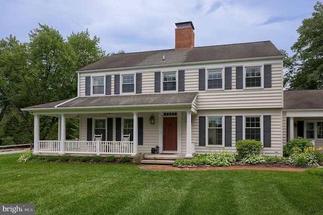 1228 Hunsicker Rd, Lancaster, PA 17601 - view of front of house with a chimney, a front lawn, covered porch, and a shingled roof