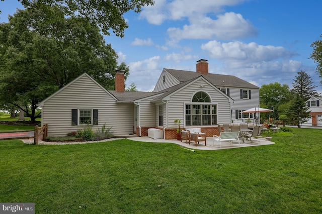 1228 Hunsicker Rd, Lancaster, PA 17601 - back of house featuring an outdoor living space, a chimney, a patio, and a yard