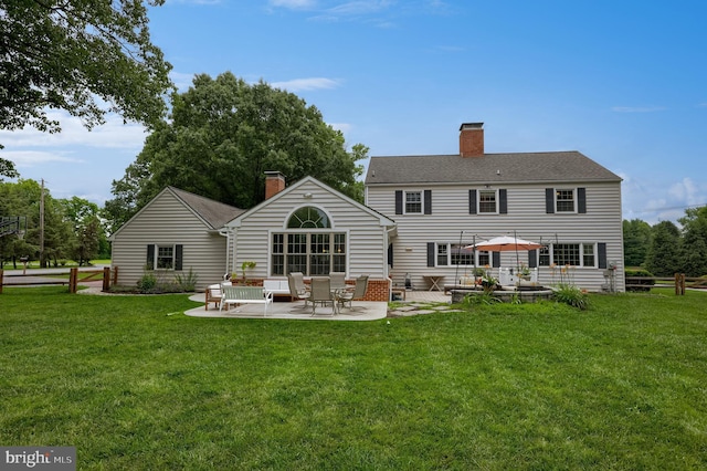 1228 Hunsicker Rd, Lancaster, PA 17601 - back of house featuring a patio, a chimney, and a lawn
