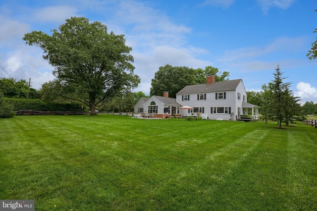 1228 Hunsicker Rd, Lancaster, PA 17601 - rear view of house featuring a chimney and a yard