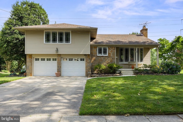 606 Hilltop Rd, Cinnaminson, NJ 08077 - tri-level home with concrete driveway, a front yard, an attached garage, a chimney, and stone siding