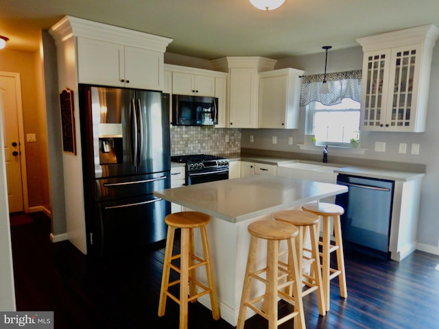 11 Rolling Ridge Dr, Milton, PA 17847 - kitchen with appliances with stainless steel finishes, dark wood-type flooring, tasteful backsplash, and white cabinets