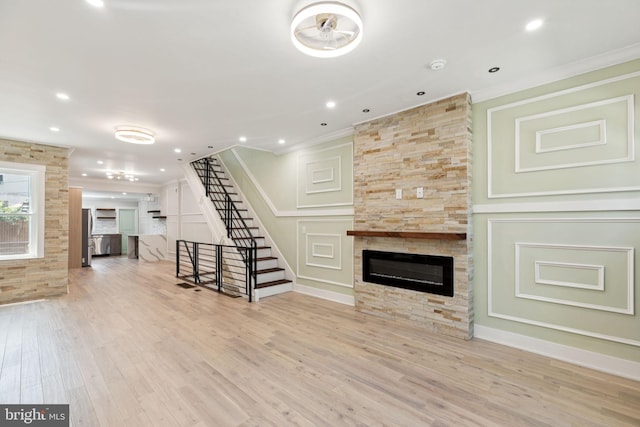 2106 E Somerset St, Philadelphia, PA 19134 - unfurnished living room with stairs, a large fireplace, crown molding, wood finished floors, and recessed lighting