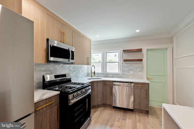 2106 E Somerset St, Philadelphia, PA 19134 - kitchen with appliances with stainless steel finishes, ornamental molding, tasteful backsplash, light wood-style floors, and light stone counters