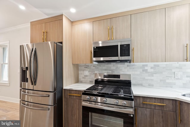2106 E Somerset St, Philadelphia, PA 19134 - kitchen with stainless steel appliances, crown molding, decorative backsplash, light stone countertops, and recessed lighting