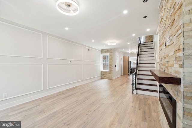 2106 E Somerset St, Philadelphia, PA 19134 - unfurnished living room featuring stairway, a decorative wall, light wood-type flooring, crown molding, and recessed lighting