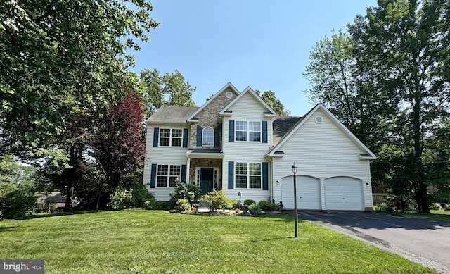 45 Boraten Rd, Royersford, PA 19468 - view of front of home featuring stone siding, driveway, a front yard, and an attached garage