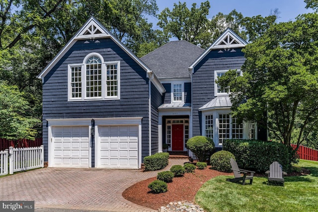 10513 Democracy Ln, Potomac, MD 20854 - view of front of house featuring an attached garage, decorative driveway, a standing seam roof, a metal roof, and a shingled roof