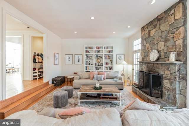 10513 Democracy Ln, Potomac, MD 20854 - living area featuring wood finished floors, a stone fireplace, and recessed lighting