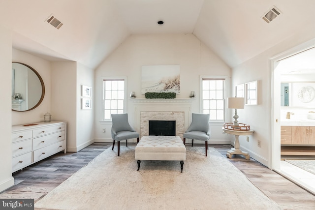 10513 Democracy Ln, Potomac, MD 20854 - living area featuring wood finished floors, vaulted ceiling, and a fireplace