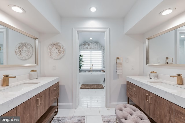 10513 Democracy Ln, Potomac, MD 20854 - bathroom featuring two vanities, a freestanding bath, tile patterned floors, and lofted ceiling