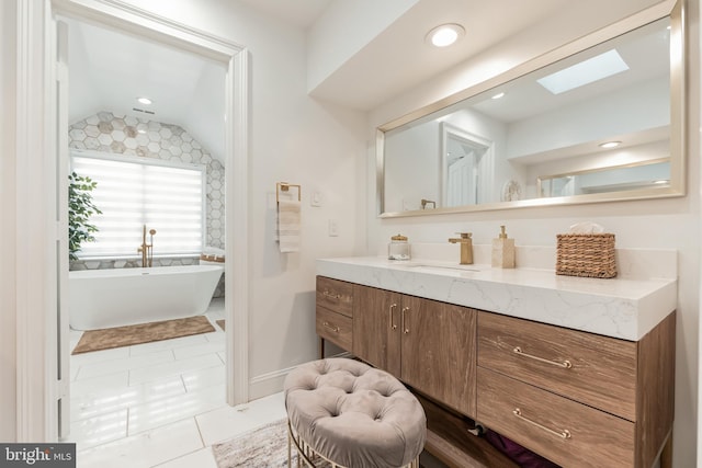 10513 Democracy Ln, Potomac, MD 20854 - full bath featuring lofted ceiling, vanity, a freestanding bath, tile patterned floors, and a skylight
