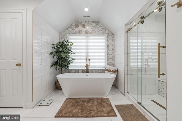 10513 Democracy Ln, Potomac, MD 20854 - bathroom featuring a freestanding bath, a shower stall, lofted ceiling, and tile walls