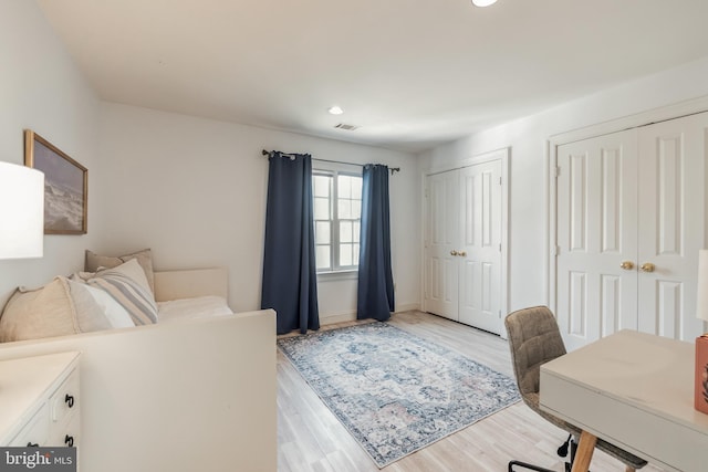 10513 Democracy Ln, Potomac, MD 20854 - bedroom featuring multiple closets, light wood-style flooring, and recessed lighting