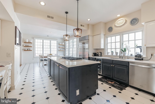 10513 Democracy Ln, Potomac, MD 20854 - kitchen with appliances with stainless steel finishes, plenty of natural light, light countertops, a kitchen island, and recessed lighting