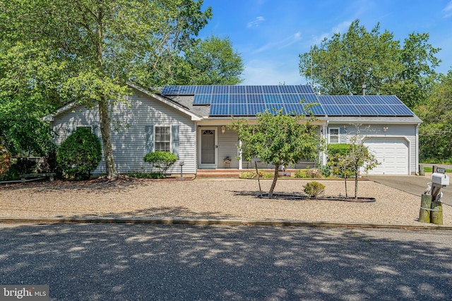 414 Riverview Rd, Forked River, NJ 08731 - ranch-style house with a garage, roof mounted solar panels, and driveway